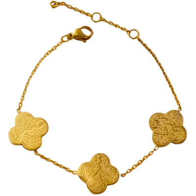 Gold bracelet with clover-shaped charms on a white background